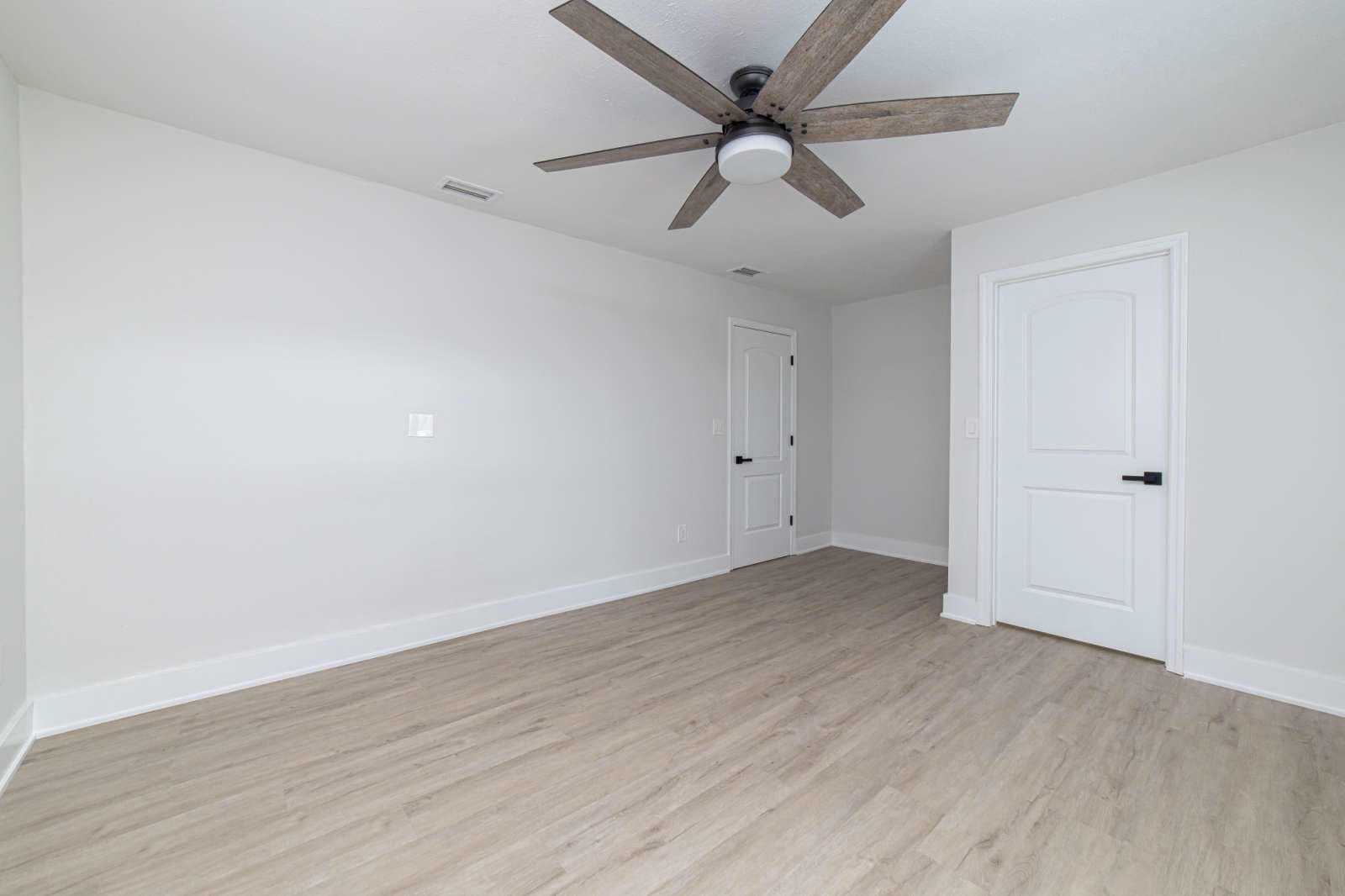 108 Linden Road St. Augustine, FL 32086 - Photo 26 of 36 an empty room with wooden floor and ceiling fan