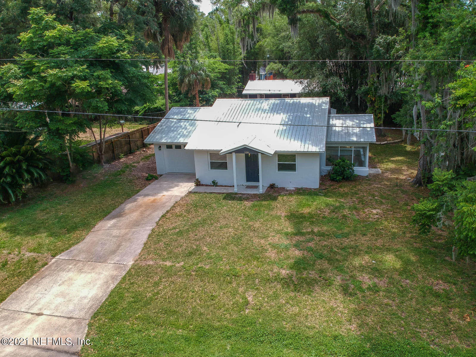 108 Linden Road St. Augustine, FL 32086 - Photo 31 of 36 a large brick building with a big yard and large trees