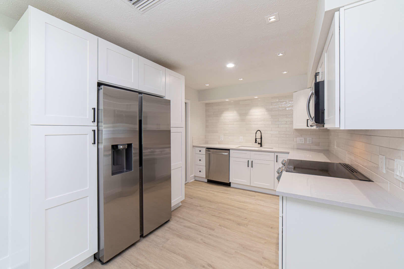 108 Linden Road St. Augustine, FL 32086 - Photo 10 of 36 a kitchen with a refrigerator sink and cabinets