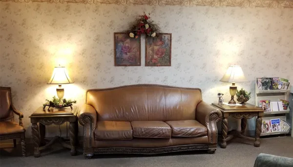 a bedroom with a bed and dresser with mirror