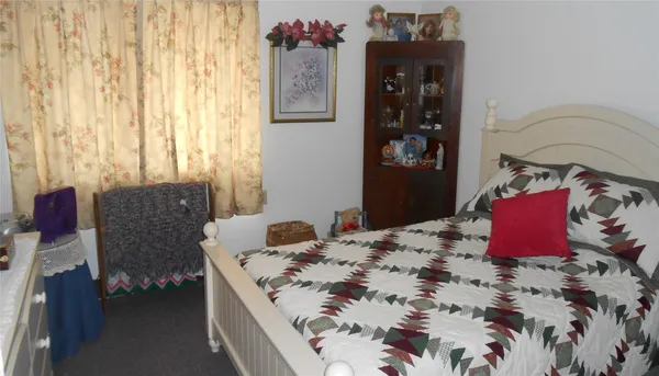 a living room with furniture and a dining table with kitchen view