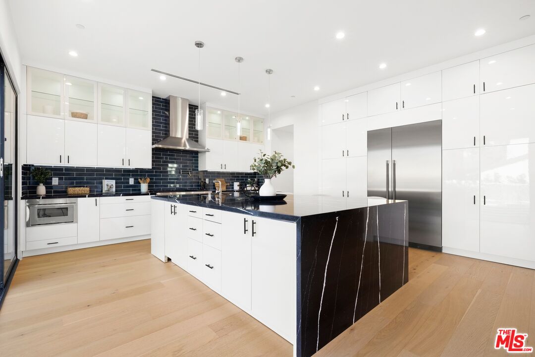 5012 Enfield Avenue Encino, CA 91316 - Photo 11 of 36 a kitchen with stainless steel appliances sink refrigerator and cabinets