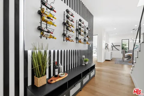 a living room with patio furniture and a floor to ceiling window