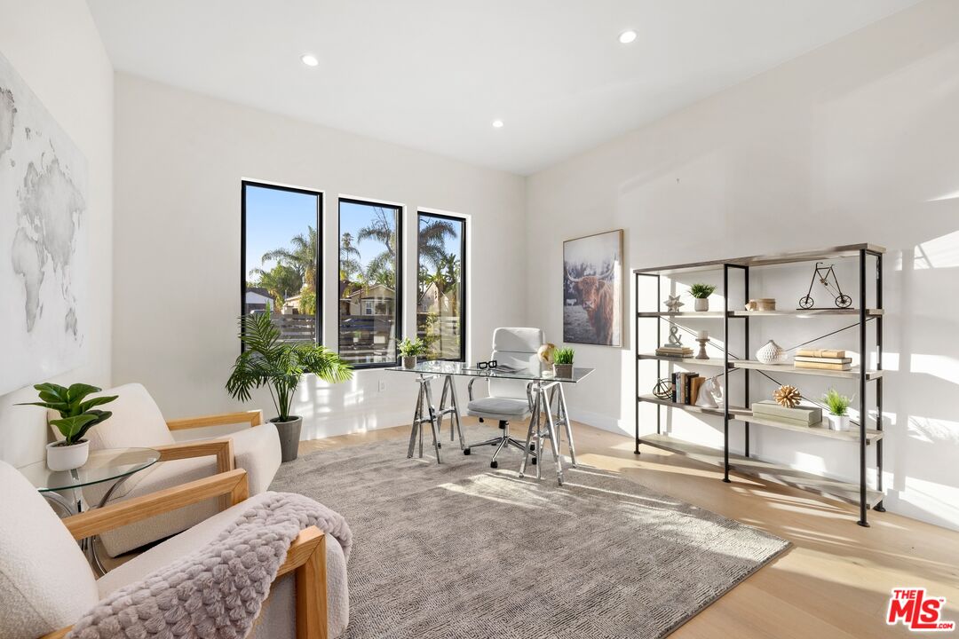 5012 Enfield Avenue Encino, CA 91316 - Photo 14 of 36 a living room with furniture and a large window