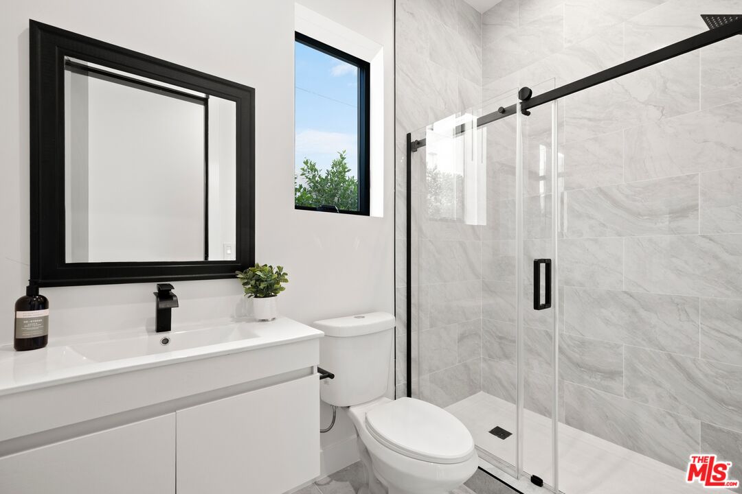 5012 Enfield Avenue Encino, CA 91316 - Photo 18 of 36 a bathroom with a sink toilet and shower