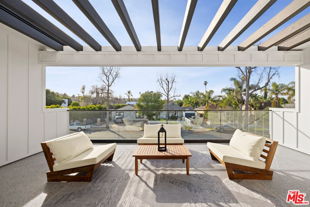 5012 Enfield Avenue Encino, CA 91316 - Photo 20 of 36 a living room with patio furniture and a floor to ceiling window