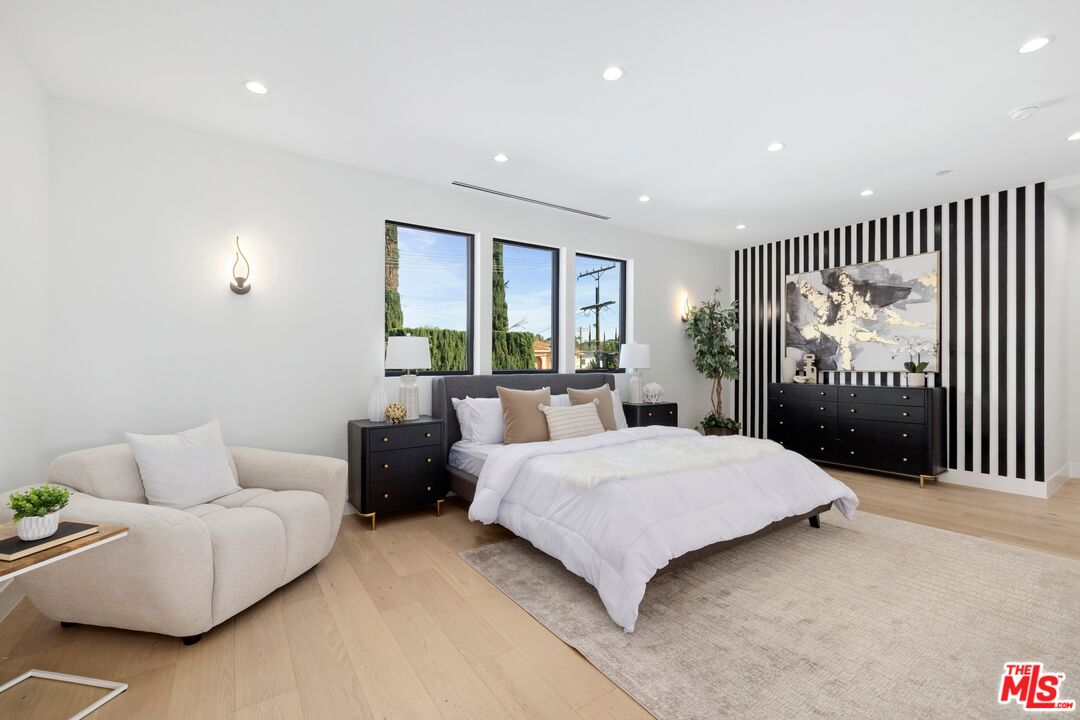 5012 Enfield Avenue Encino, CA 91316 - Photo 22 of 36 a spacious bedroom with a bed and glass door