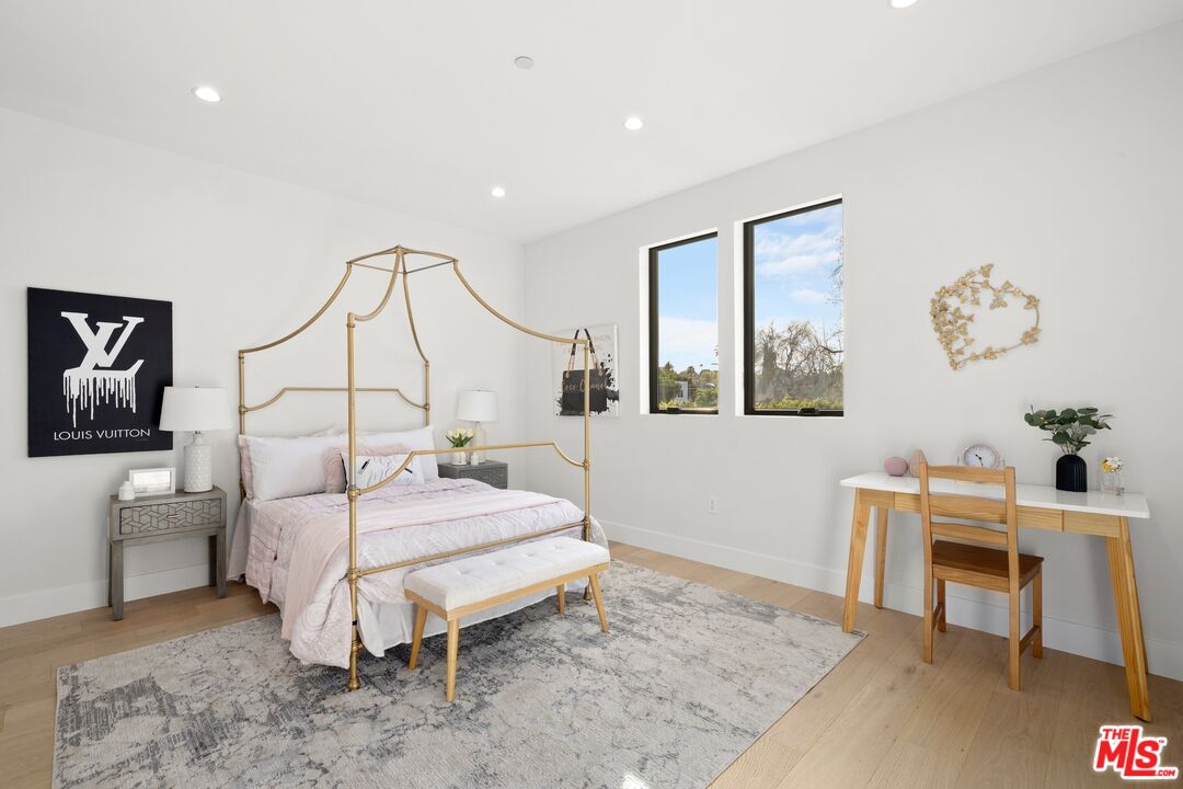 5012 Enfield Avenue Encino, CA 91316 - Photo 29 of 36 a bedroom with a bed and a table