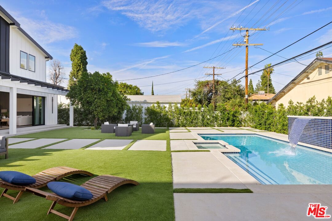 5012 Enfield Avenue Encino, CA 91316 - Photo 33 of 36 a view of a swimming pool with a yard