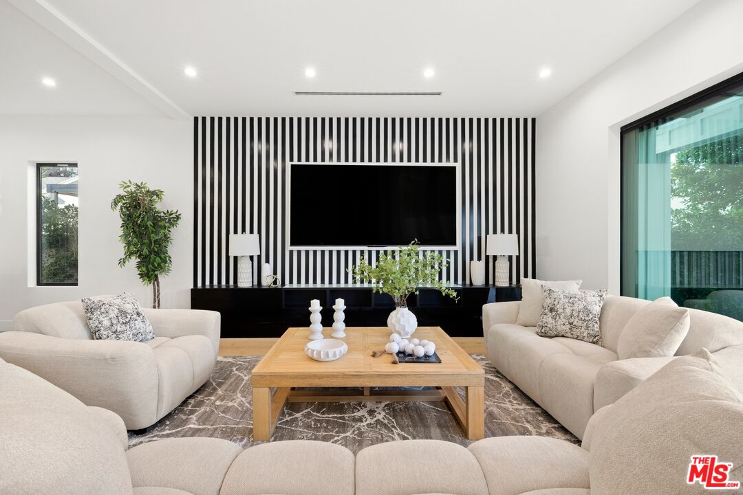 5012 Enfield Avenue Encino, CA 91316 - Photo 6 of 36 a living room with furniture and a large window