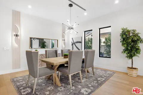 a living room with furniture tv and large window