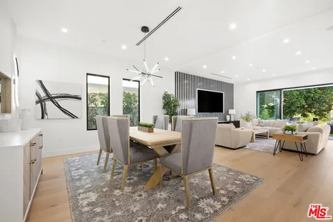 a kitchen with stainless steel appliances kitchen island granite countertop a stove a sink and a refrigerator