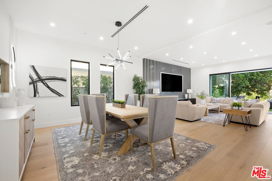 5012 Enfield Avenue Encino, CA 91316 - Photo 8 of 36 a living room with couches a coffee table and a flat screen tv