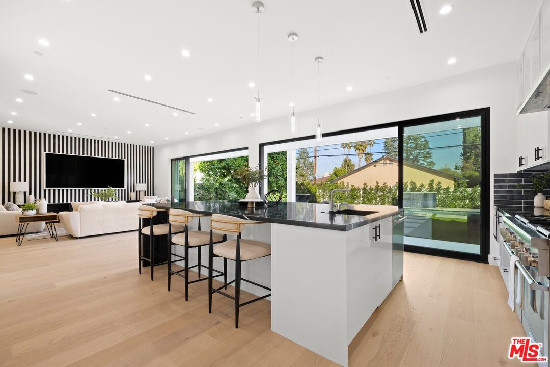 5012 Enfield Avenue Encino, CA 91316 - Photo 9 of 36 a living room with furniture tv and large window