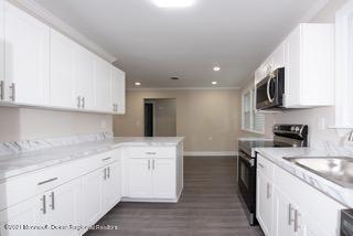 6 Churchill Road Whiting, NJ 08759 - Photo 8 of 30 a kitchen with a sink stove and cabinets