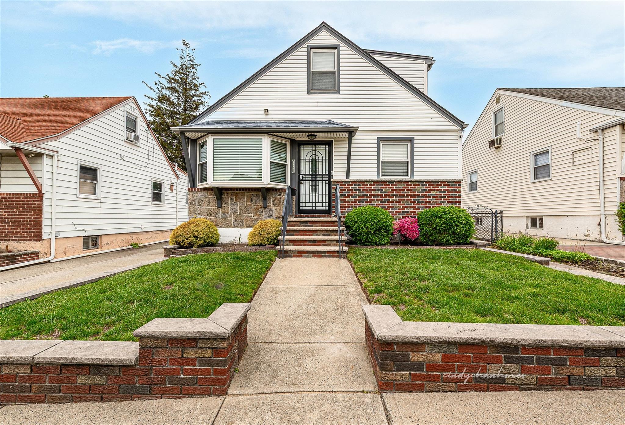 199-35 24th Road Queens, NY 11357 - Photo 1 of 1 a front view of a house with a garden