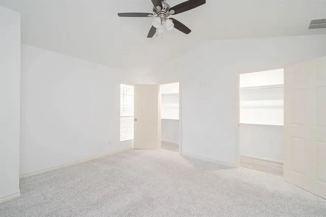 a view of an empty room and a window