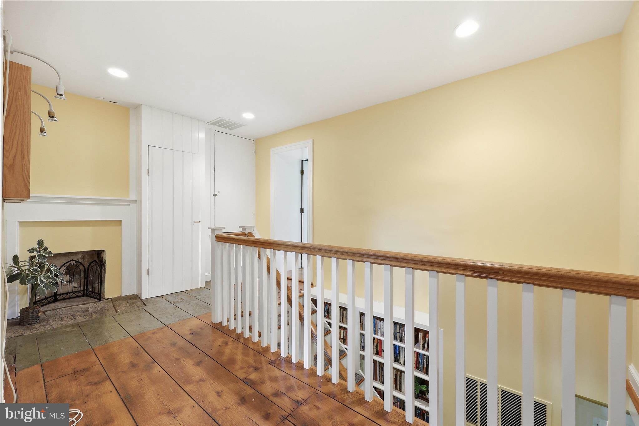 10919 Etzler Mill Road Woodsboro, MD 21798 - Photo 20 of 54 a view of a room with wooden floor staircase and a fireplace