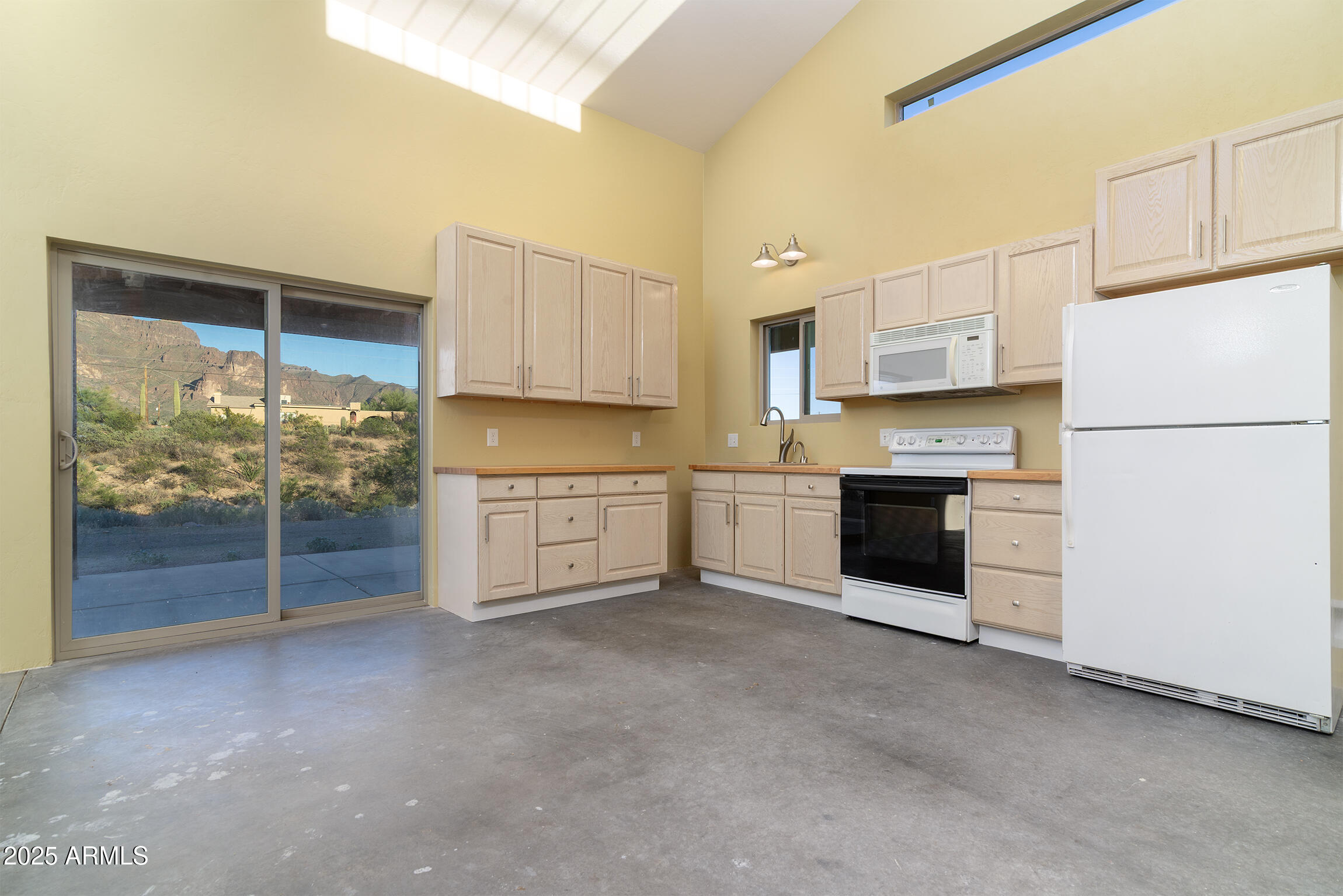 4129 East Roundup Street Apache Junction, AZ 85119 - Photo 13 of 42 a kitchen with stainless steel appliances a refrigerator sink and cabinets