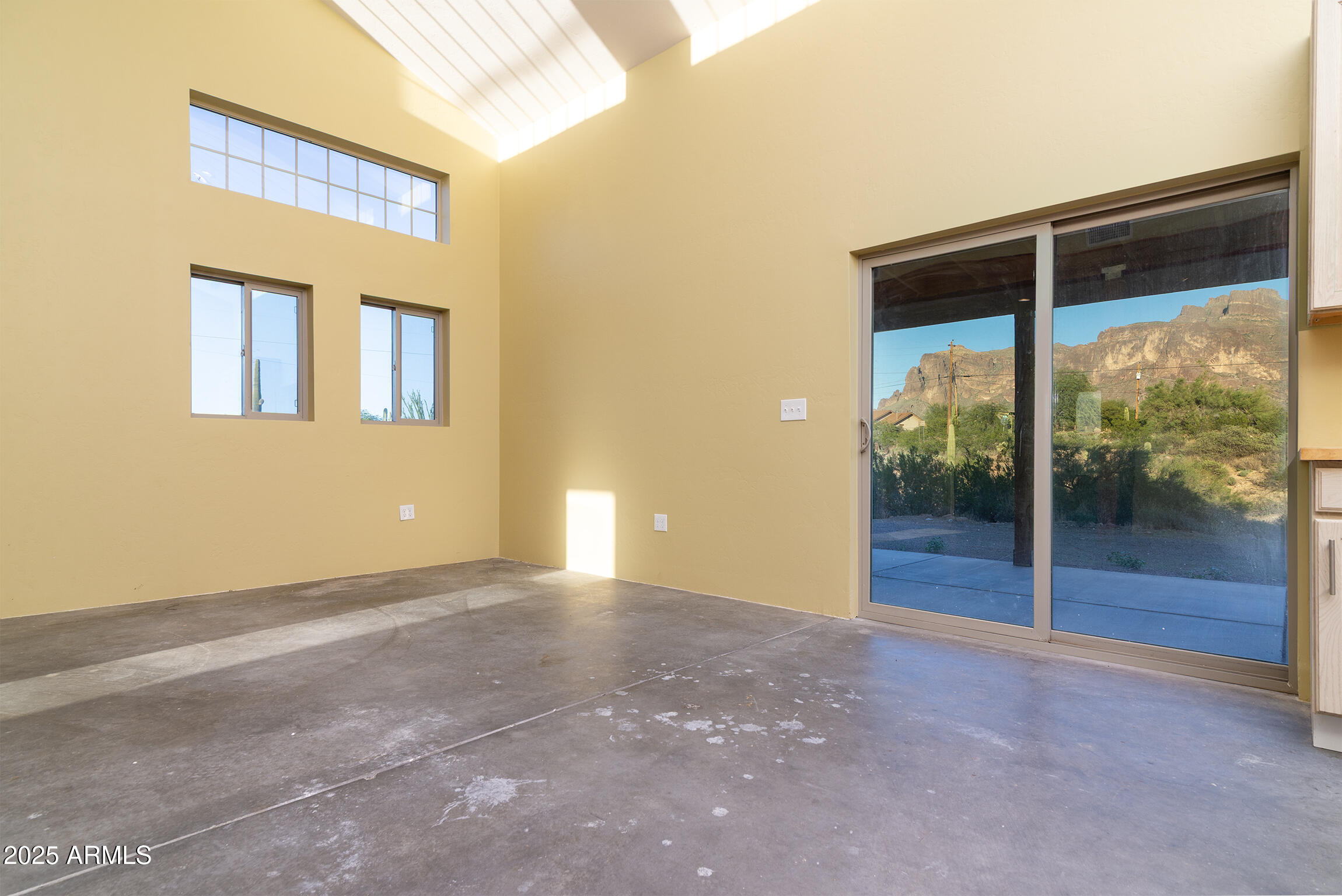 4129 East Roundup Street Apache Junction, AZ 85119 - Photo 14 of 42 a view of an empty room with wooden floor and windows