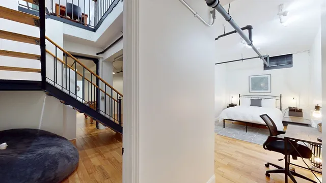 a view of entryway livingroom and hall with wooden floor