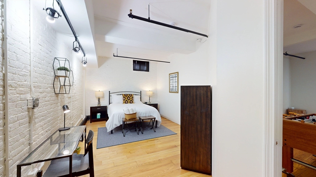 19 Stanhope Street, Unit 1C Boston, MA 02116 - Photo 15 of 19 a living room with furniture and a flat screen tv