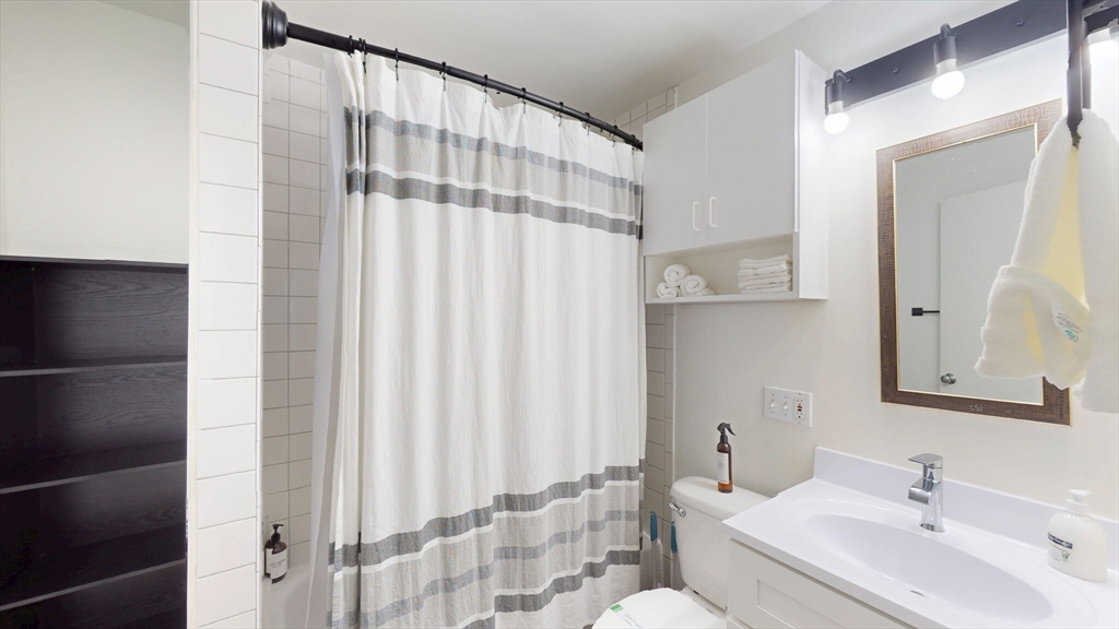 19 Stanhope Street, Unit 1C Boston, MA 02116 - Photo 18 of 19 a bathroom with a sink and a mirror