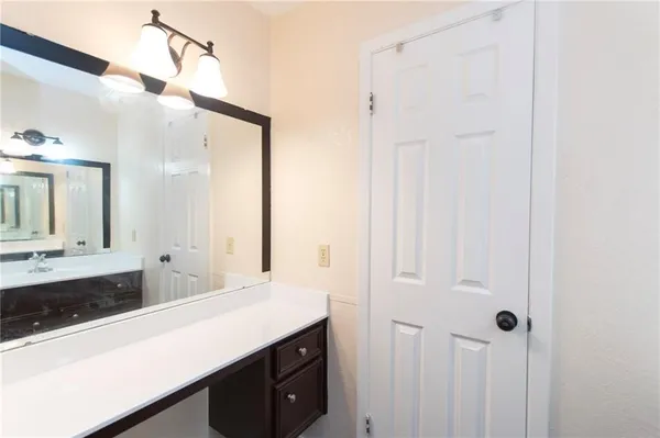 a bathroom with a double vanity sink and mirror