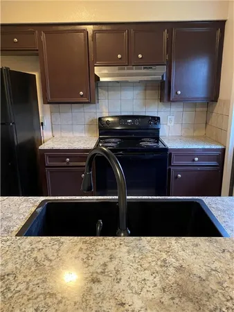 a kitchen with a sink and a stove