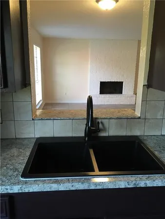 a kitchen with a sink and a stove top oven