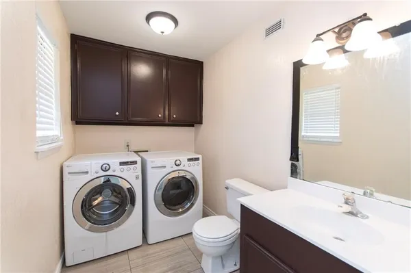 a view of a bathroom with washing machine and washing machine