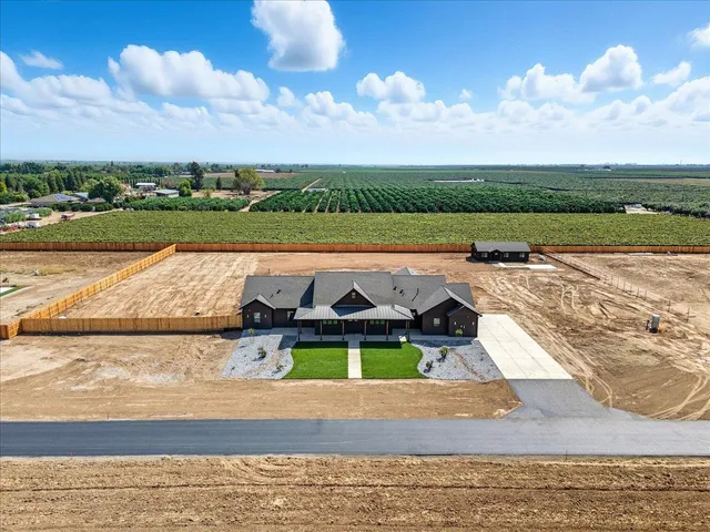 a view of a dining room with furniture and a chandelier