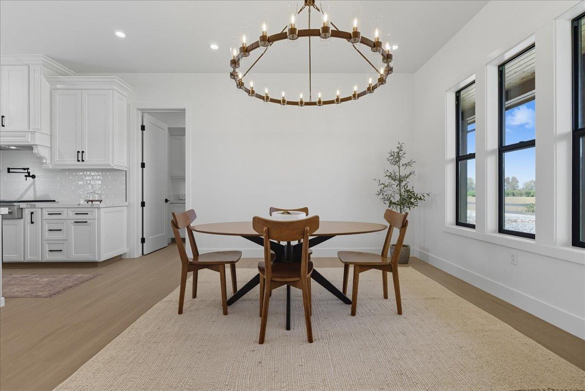 605 South Anderson Road Exeter, CA 93221 - Photo 16 of 81 a view of a dining room with furniture and a chandelier