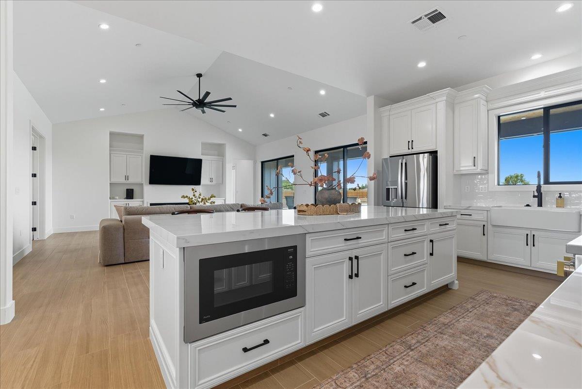 605 South Anderson Road Exeter, CA 93221 - Photo 22 of 81 a kitchen with stainless steel appliances white cabinets and a fireplace