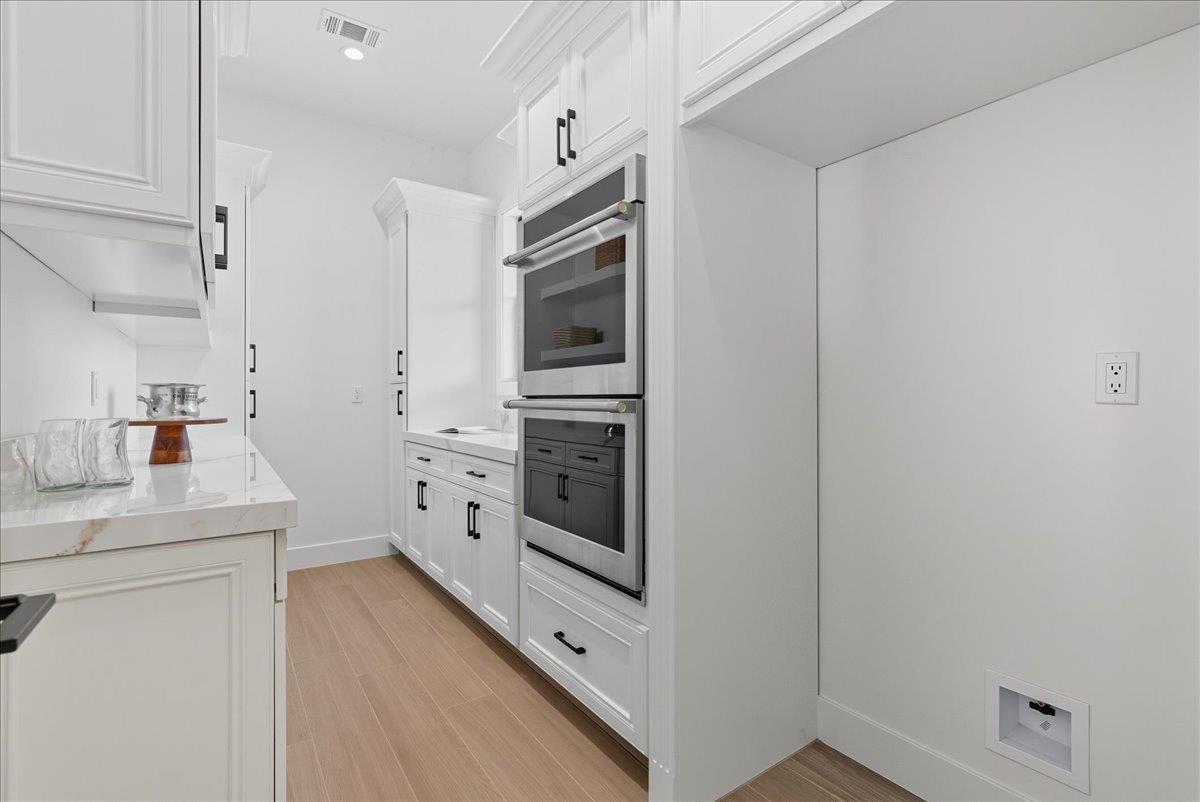 605 South Anderson Road Exeter, CA 93221 - Photo 26 of 81 a kitchen with white cabinets and white appliances