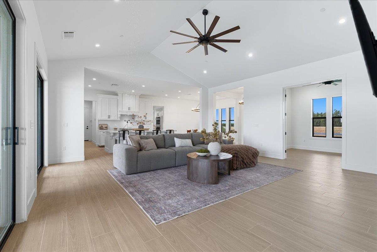 605 South Anderson Road Exeter, CA 93221 - Photo 30 of 81 a living room with furniture a view of kitchen and a dining table with kitchen view