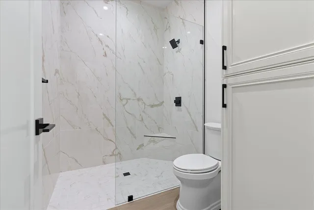 a spacious bathroom with a double vanity sink a mirror and a shower