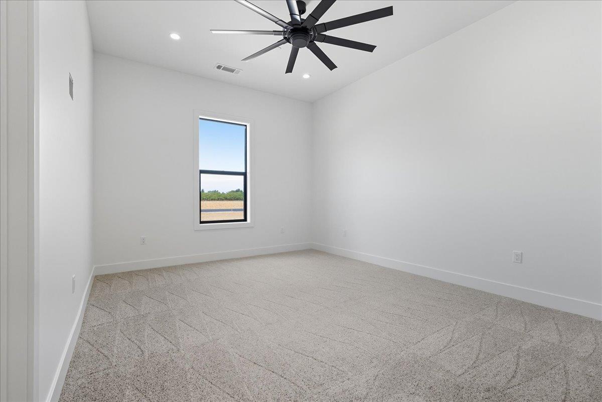 605 South Anderson Road Exeter, CA 93221 - Photo 39 of 81 an empty room with windows and fan