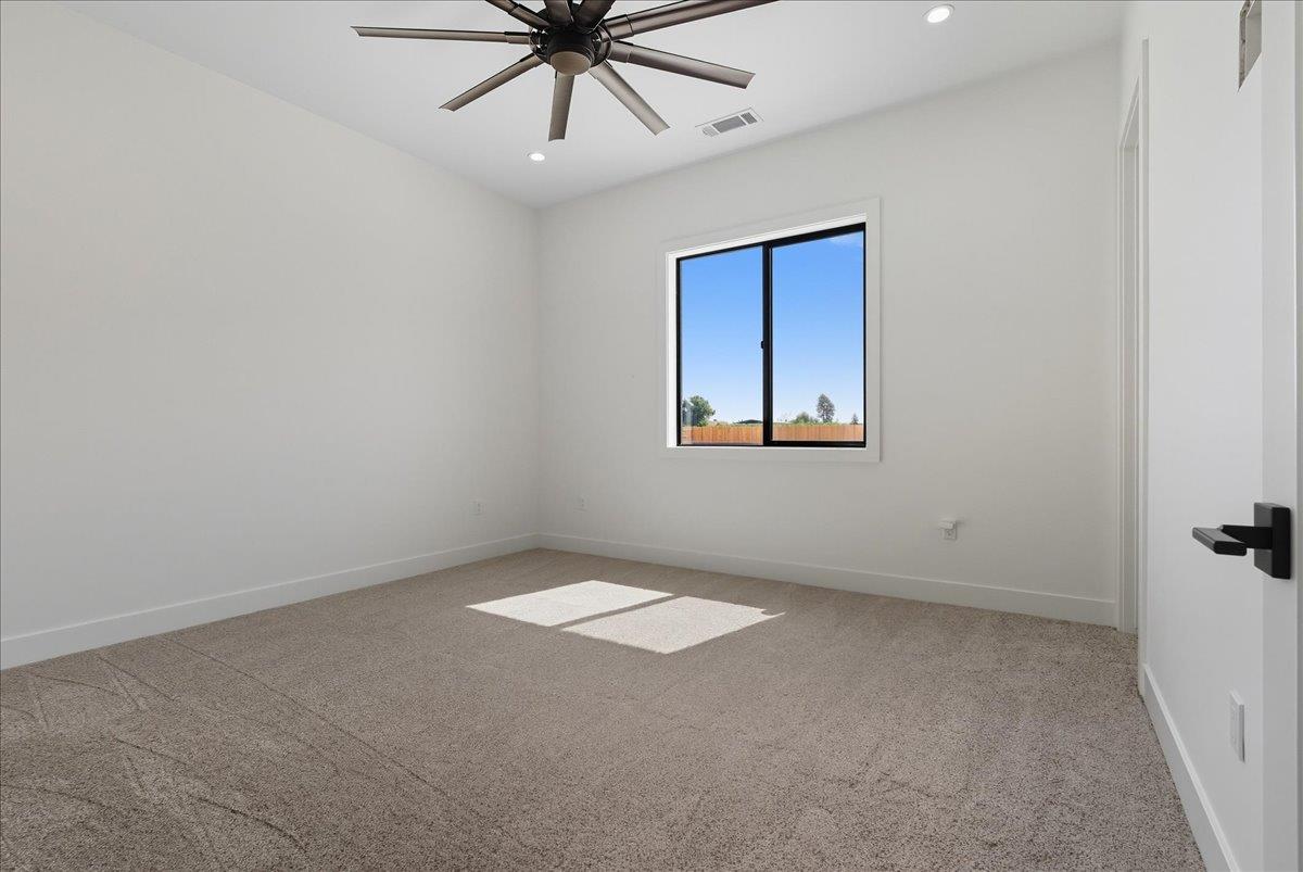 605 South Anderson Road Exeter, CA 93221 - Photo 41 of 81 an empty room with a window and a fan