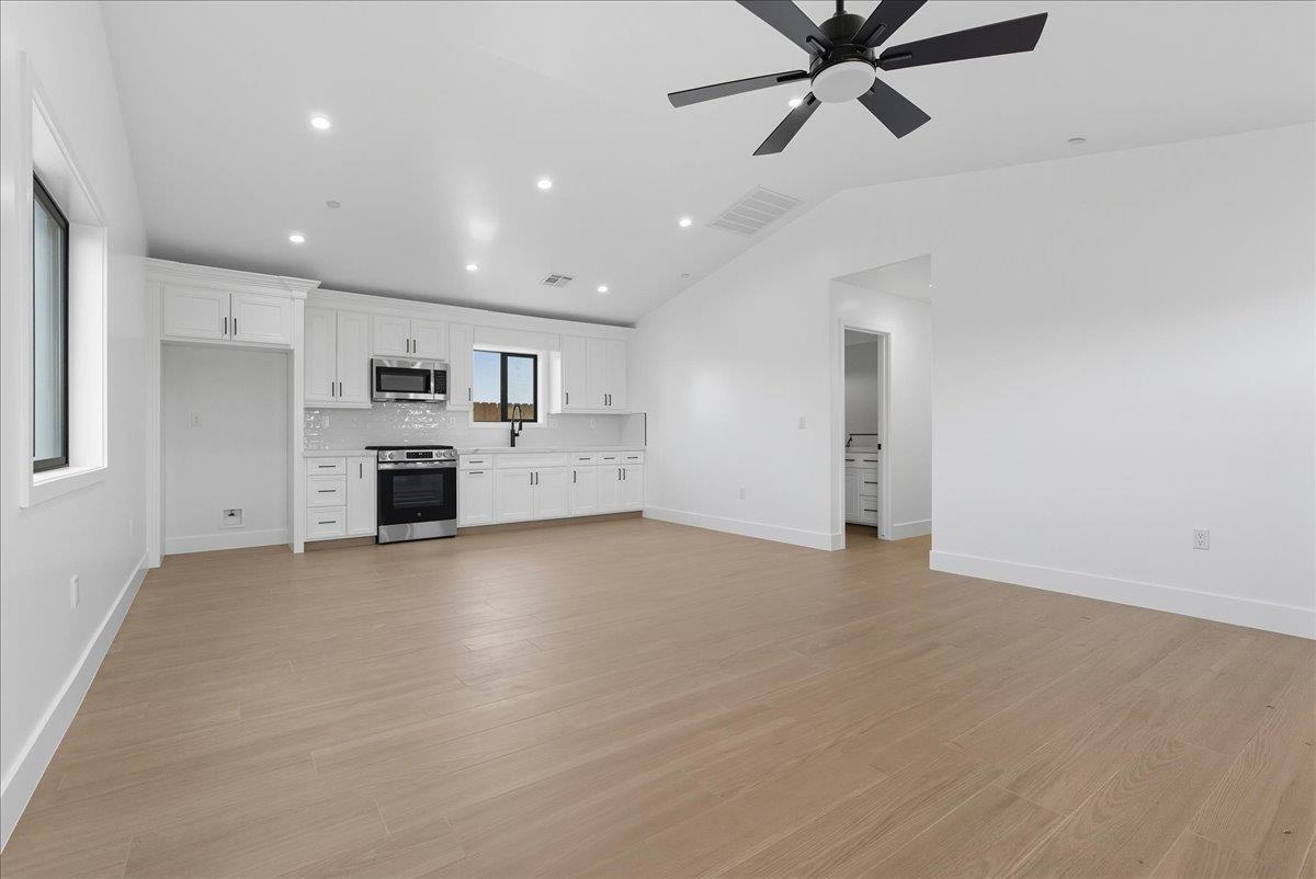605 South Anderson Road Exeter, CA 93221 - Photo 72 of 81 a view of a kitchen with a sink and a stove top oven
