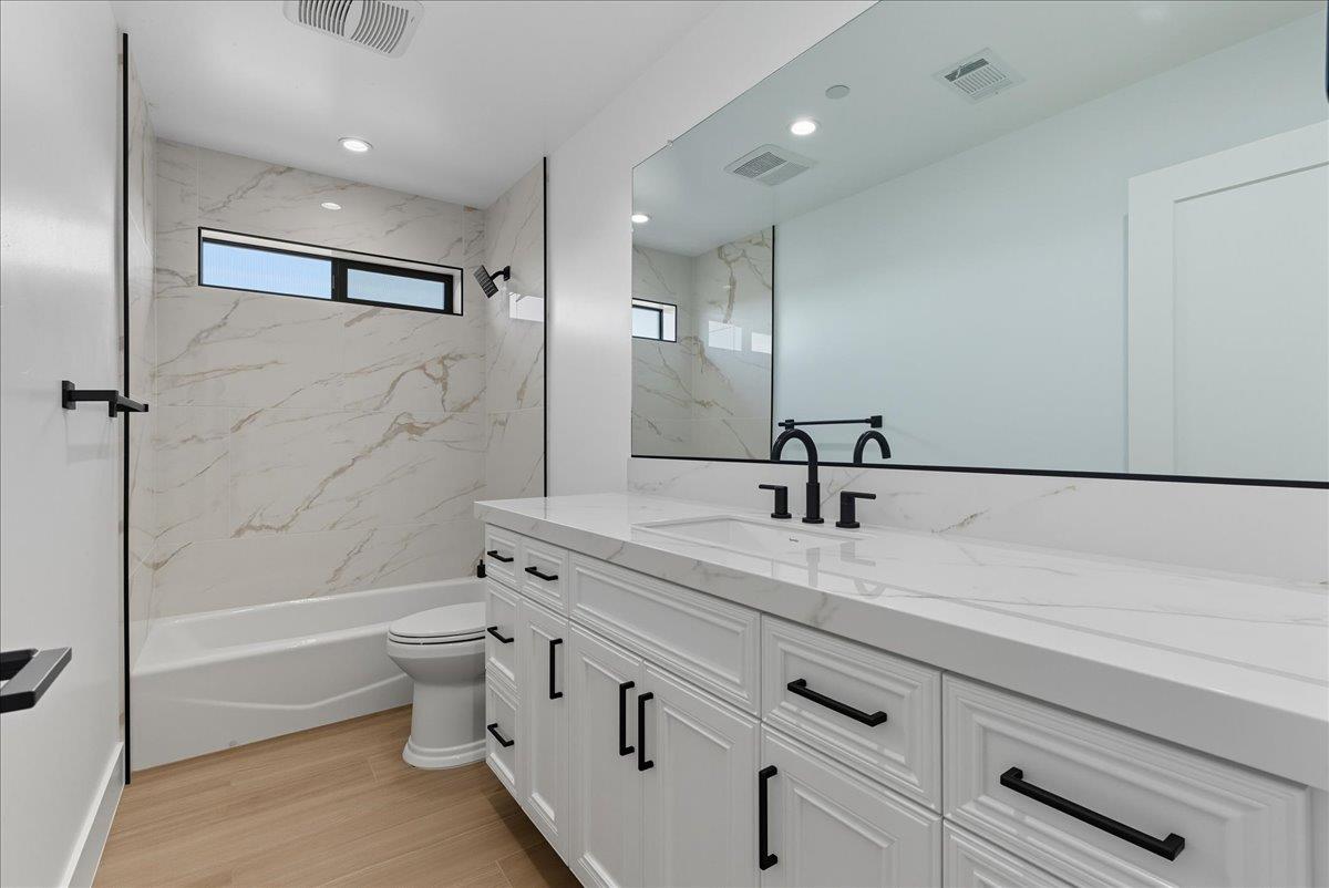 605 South Anderson Road Exeter, CA 93221 - Photo 75 of 81 a bathroom with a granite countertop sink a toilet and shower