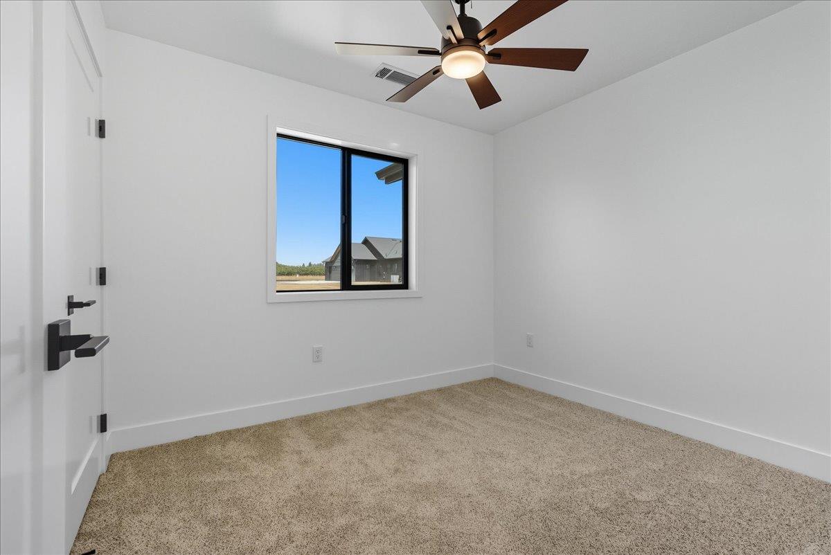 605 South Anderson Road Exeter, CA 93221 - Photo 76 of 81 an empty room with a window and a fan
