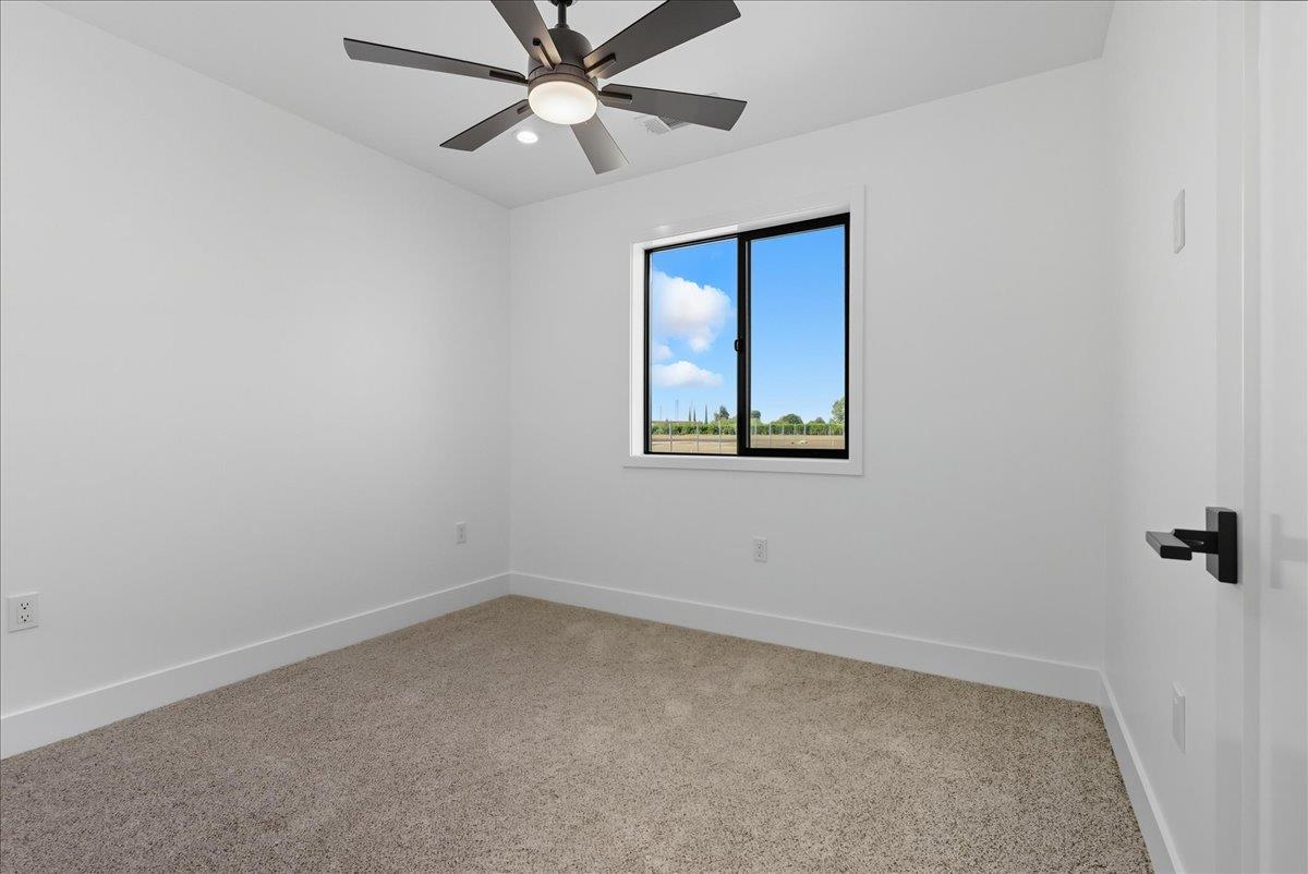 605 South Anderson Road Exeter, CA 93221 - Photo 77 of 81 an empty room with a window and a fan