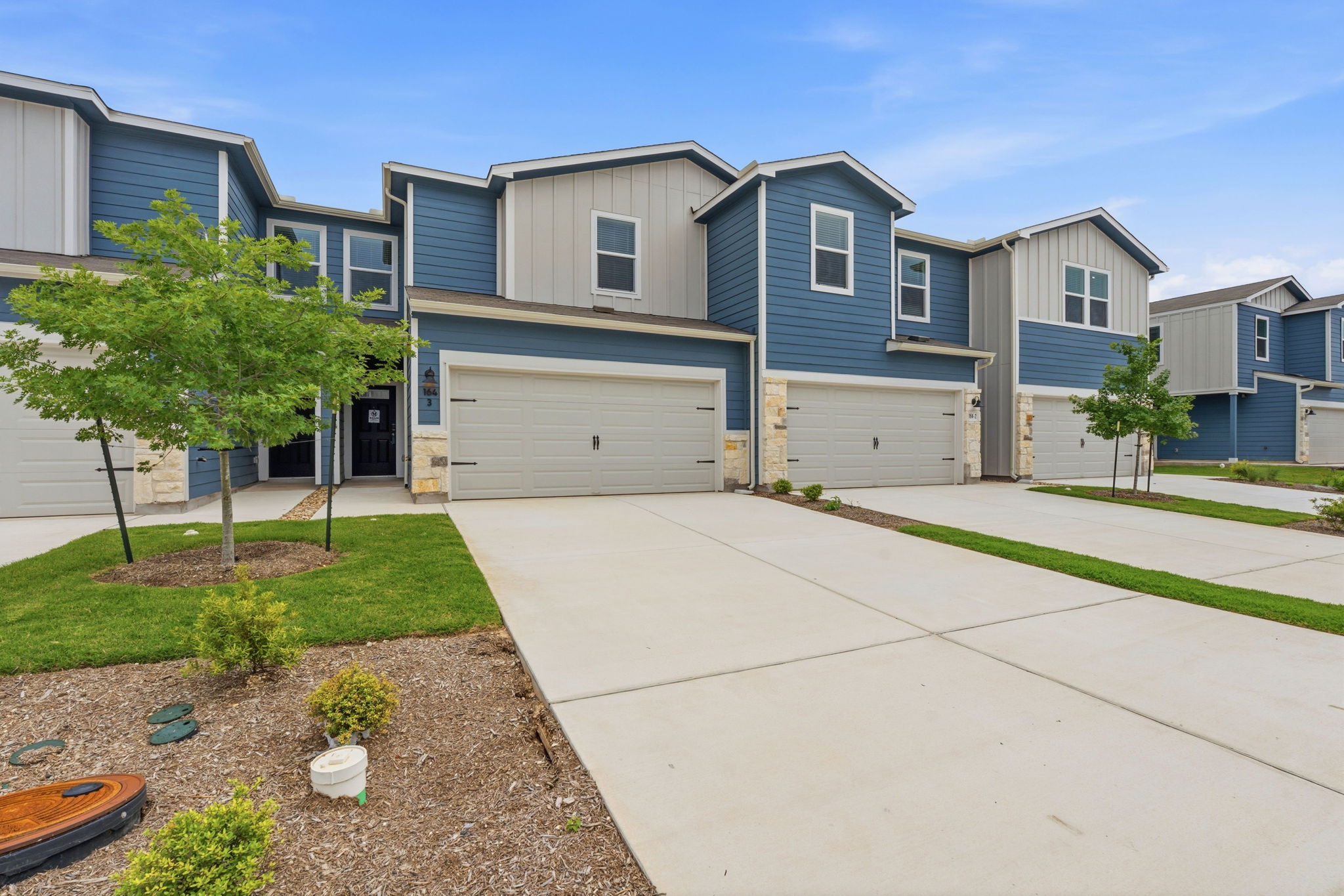164 Cinnabar Lane, Unit 3 Kyle, TX 78640 - Photo 1 of 20 Contemporary townhome with blue siding and light grey vertical accents