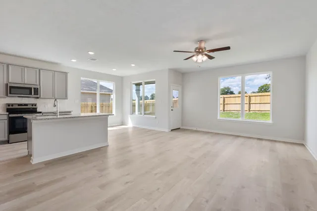 a view of a kitchen with microwave and windows