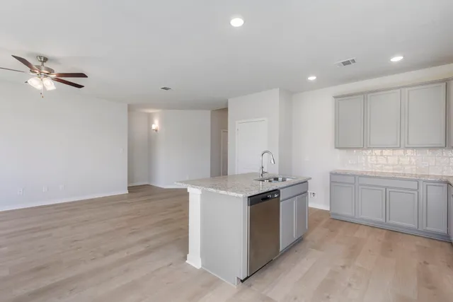 a kitchen with a sink and cabinets