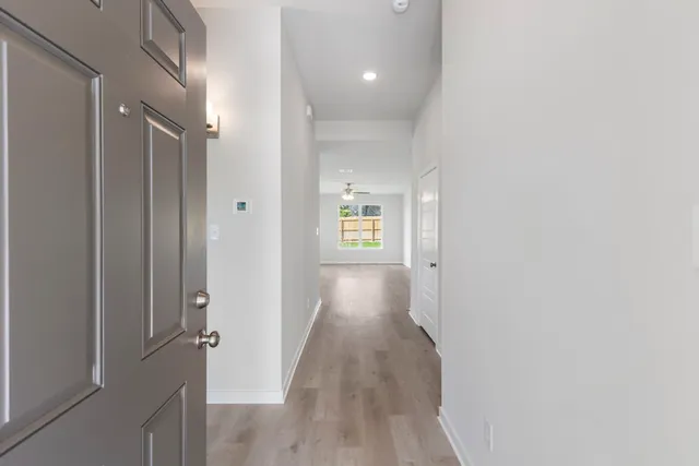a view of hallway with wooden floor