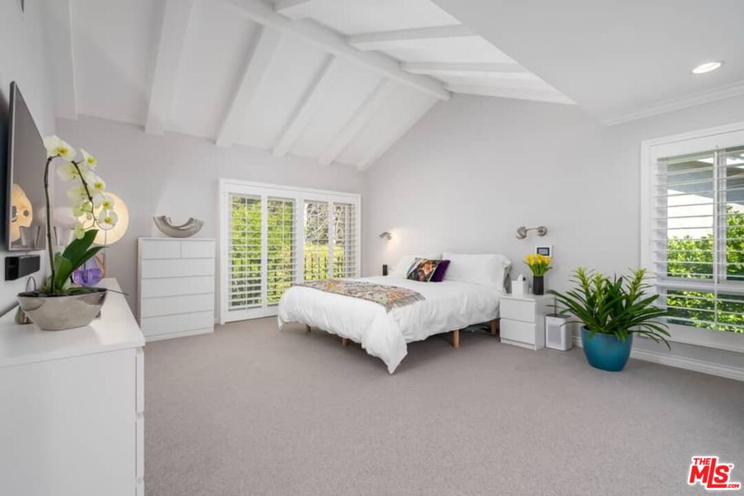 3104 Hutton Drive Beverly Hills, CA 90210 - Photo 17 of 37 a bed sitting in a spacious bedroom next to a window
