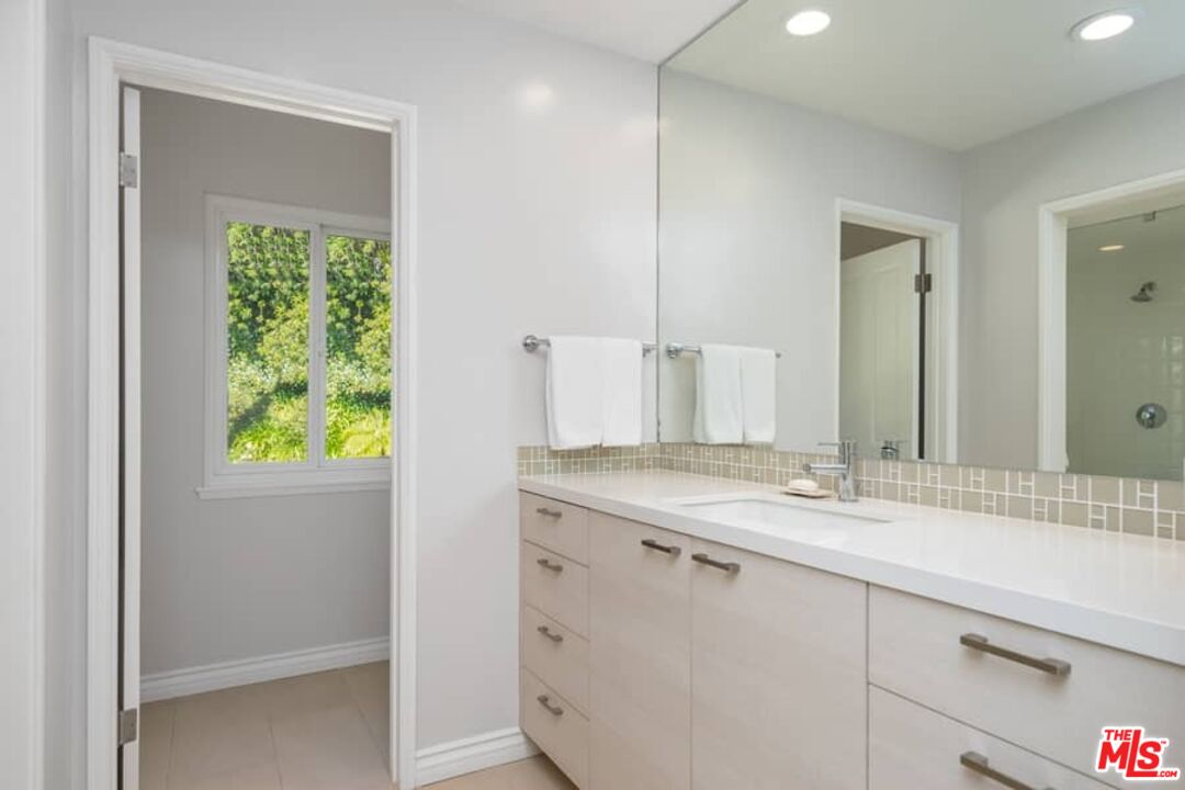 3104 Hutton Drive Beverly Hills, CA 90210 - Photo 19 of 37 a bathroom with a granite countertop sink and a mirror