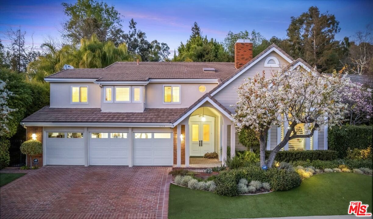 3104 Hutton Drive Beverly Hills, CA 90210 - Photo 2 of 37 a front view of a house with a yard and garage